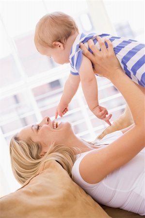 simsearch:400-04045907,k - Mother in living room holding baby smiling Stock Photo - Budget Royalty-Free & Subscription, Code: 400-04045895