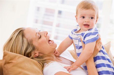simsearch:400-04045907,k - Mother in living room holding baby smiling Stock Photo - Budget Royalty-Free & Subscription, Code: 400-04045897