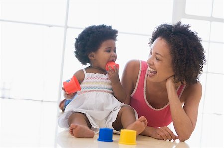 Mother and daughter indoors playing and smiling Stock Photo - Budget Royalty-Free & Subscription, Code: 400-04045905
