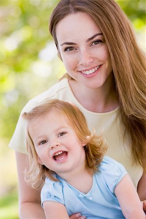 simsearch:400-04043055,k - Mother holding daughter outdoors smiling Stock Photo - Budget Royalty-Free & Subscription, Code: 400-04045914