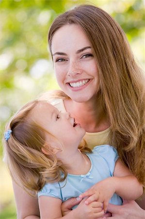 simsearch:400-04045907,k - Mother holding daughter outdoors smiling Stock Photo - Budget Royalty-Free & Subscription, Code: 400-04045915