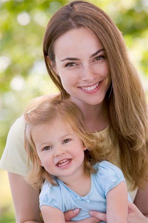 simsearch:400-04043055,k - Mother holding daughter outdoors smiling Stock Photo - Budget Royalty-Free & Subscription, Code: 400-04045916