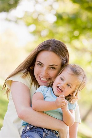 simsearch:400-04045907,k - Mother holding daughter outdoors smiling Stock Photo - Budget Royalty-Free & Subscription, Code: 400-04045917