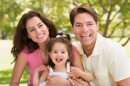simsearch:400-04045907,k - Family sitting outdoors smiling Stock Photo - Budget Royalty-Free & Subscription, Code: 400-04045910