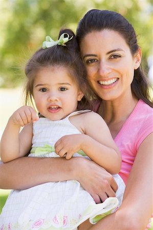 simsearch:400-04045907,k - Mother holding daughter outdoors smiling Stock Photo - Budget Royalty-Free & Subscription, Code: 400-04045912