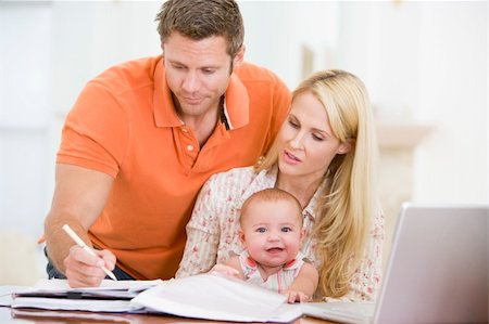Couple and baby in dining room with laptop Stock Photo - Budget Royalty-Free & Subscription, Code: 400-04045934