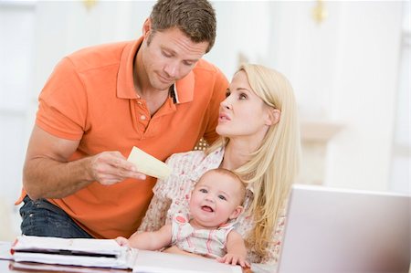 Couple and baby in dining room with laptop and paperwork Stock Photo - Budget Royalty-Free & Subscription, Code: 400-04045935