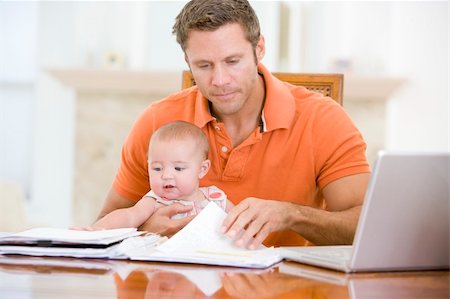 Father and baby in dining room with laptop Stock Photo - Budget Royalty-Free & Subscription, Code: 400-04045936