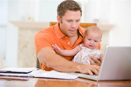 Father and baby in dining room with laptop Stock Photo - Budget Royalty-Free & Subscription, Code: 400-04045937