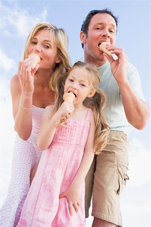 Family standing outdoors with ice cream Stock Photo - Budget Royalty-Free & Subscription, Code: 400-04045947