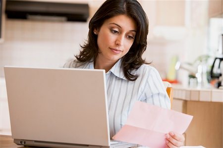 Woman in kitchen with laptop Stock Photo - Budget Royalty-Free & Subscription, Code: 400-04046226