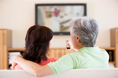 simsearch:400-04046300,k - Couple watching television using remote control Stock Photo - Budget Royalty-Free & Subscription, Code: 400-04046298