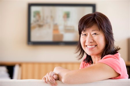 simsearch:400-04046300,k - Woman watching television smiling Stock Photo - Budget Royalty-Free & Subscription, Code: 400-04046301