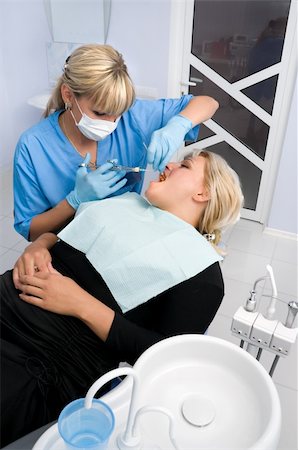 starush (artist) - female dentist works with patient the office Stockbilder - Microstock & Abonnement, Bildnummer: 400-04047133