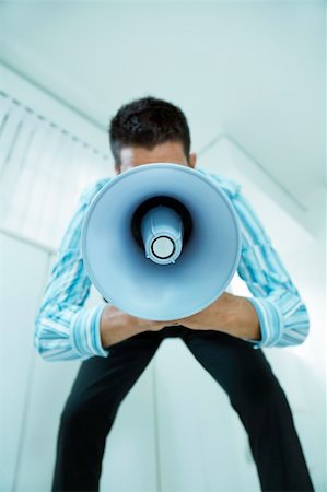 young businessman in office talking on the megaphone Stock Photo - Budget Royalty-Free & Subscription, Code: 400-04047872