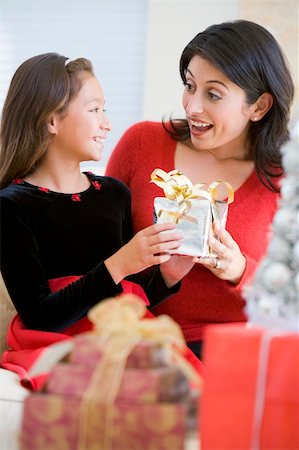 Girl Surprising Her Mother With Christmas Gift Stock Photo - Budget Royalty-Free & Subscription, Code: 400-04047969