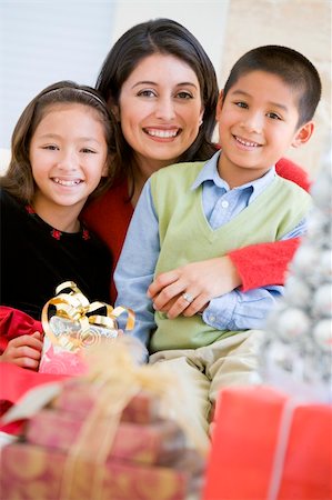 Mother With Her Daughter And Son Holding Christmas Gifts Stock Photo - Budget Royalty-Free & Subscription, Code: 400-04047975