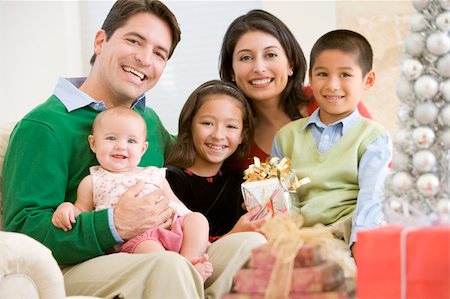 Family With New Born,Sitting On Sofa,Holding Christmas Gift Stock Photo - Budget Royalty-Free & Subscription, Code: 400-04047978