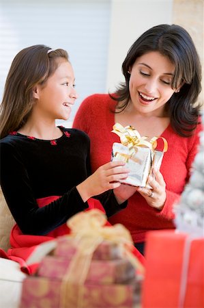 Girl Surprising Her Mother With Christmas Gift Stock Photo - Budget Royalty-Free & Subscription, Code: 400-04047970