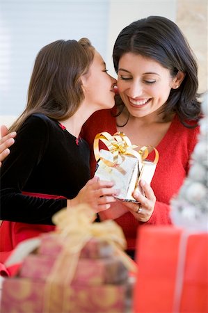 Girl Surprising Her Mother With Christmas Gift Stock Photo - Budget Royalty-Free & Subscription, Code: 400-04047971