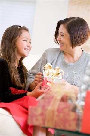 Grandmother And Granddaughter Exchanging Christmas Gifts Stock Photo - Budget Royalty-Free & Subscription, Code: 400-04047988