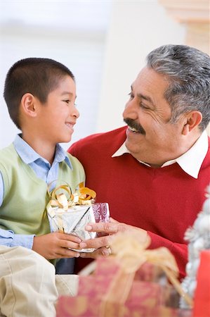 Boy Surprising Father With Christmas Present Stock Photo - Budget Royalty-Free & Subscription, Code: 400-04047996