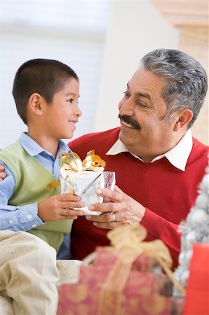 Boy Surprising Father With Christmas Present Stock Photo - Budget Royalty-Free & Subscription, Code: 400-04047993