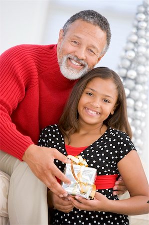 Grandfather Giving His Granddaughter A Christmas Present Stock Photo - Budget Royalty-Free & Subscription, Code: 400-04048037