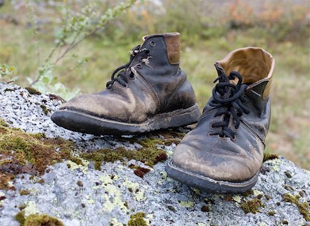 damaged shoe - Standing on a stone, the old torn boots Stock Photo - Budget Royalty-Free & Subscription, Code: 400-04048338