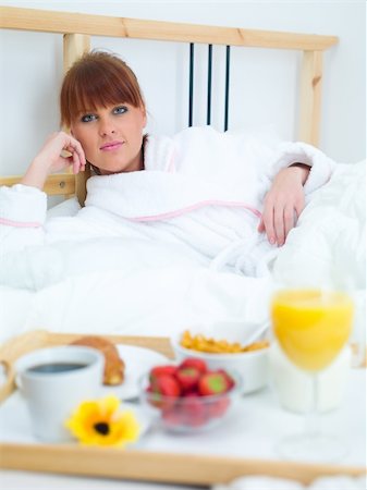 Beautiful woman eating breakfast in bed Stock Photo - Budget Royalty-Free & Subscription, Code: 400-04048390