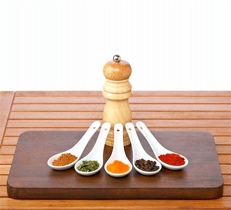 simsearch:400-03908268,k - Assortment of spices in the spoons and pepper grinder in the wooden background. Shallow depth of field Photographie de stock - Aubaine LD & Abonnement, Code: 400-04048650