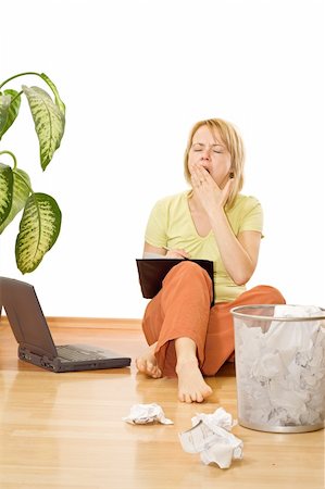 recycle bins for the home - Woman with too much work yawning sitting on the floor - isloated Stock Photo - Budget Royalty-Free & Subscription, Code: 400-04049389