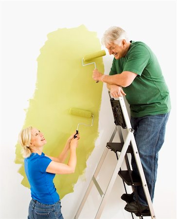 Middle-aged couple painting wall green with male on ladder. Stock Photo - Budget Royalty-Free & Subscription, Code: 400-04040039