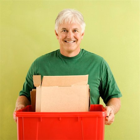 recycled cardboard person - Portrait of smiling adult man holding recycling bin full of cardboard. Stock Photo - Budget Royalty-Free & Subscription, Code: 400-04040059