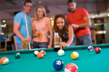 simsearch:400-04040273,k - Young couples playing pool in a bar (focus on pool table) Stock Photo - Budget Royalty-Free & Subscription, Code: 400-04040273