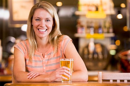 simsearch:400-05343153,k - Young woman enjoying a beer at a bar Fotografie stock - Microstock e Abbonamento, Codice: 400-04040286