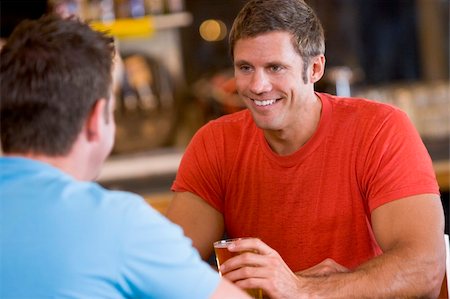 simsearch:400-05343153,k - Two men talking over beer in a bar Fotografie stock - Microstock e Abbonamento, Codice: 400-04040294