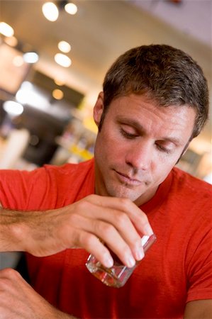 Young man at bar staring forlornly into drink Stock Photo - Budget Royalty-Free & Subscription, Code: 400-04040295