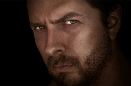 simsearch:400-05347590,k - Low-key portrait of man with mysterious eyes Stockbilder - Microstock & Abonnement, Bildnummer: 400-04040443