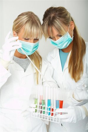 simsearch:400-03955643,k - Female lab workers testing and experimenting Stock Photo - Budget Royalty-Free & Subscription, Code: 400-04040831