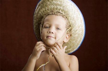 Little boy with curly hair and blue eyes in a straw hat Stock Photo - Budget Royalty-Free & Subscription, Code: 400-04040937