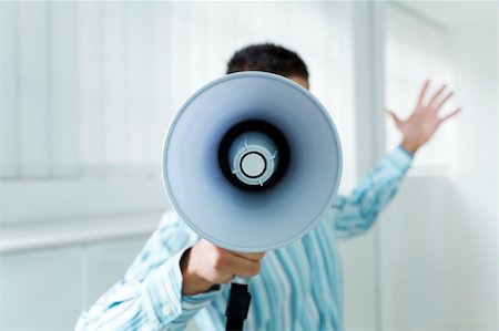 young businessman in office screaming on the megaphone Stock Photo - Budget Royalty-Free & Subscription, Code: 400-04041002