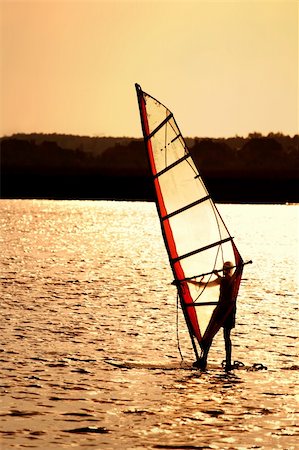 Silhouette of a windsurfing sail in the sunset Stock Photo - Budget Royalty-Free & Subscription, Code: 400-04041044