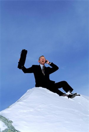 Businessman outdoors on snowy mountain using cellular phone and Stock Photo - Budget Royalty-Free & Subscription, Code: 400-04041662