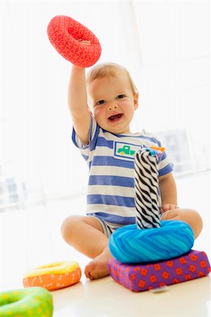 Baby indoors playing with soft toy Stock Photo - Budget Royalty-Free & Subscription, Code: 400-04041777