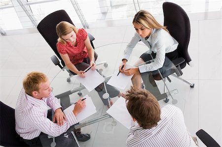 Four businesspeople in a boardroom with paperwork Stock Photo - Budget Royalty-Free & Subscription, Code: 400-04041891