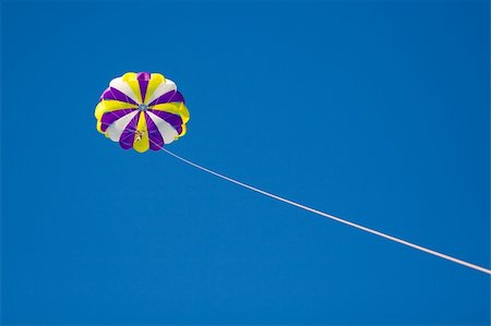 parasailing fun - Parachute in the sky tether by cord Photographie de stock - Aubaine LD & Abonnement, Code: 400-04042102