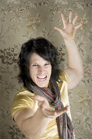 Rock and Roll Hipster in a tight yellow shirt gesturing with his hands Stock Photo - Budget Royalty-Free & Subscription, Code: 400-04042118