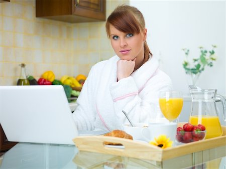 Beautiful woman in kitchen eating tasty breakfast Stock Photo - Budget Royalty-Free & Subscription, Code: 400-04042374