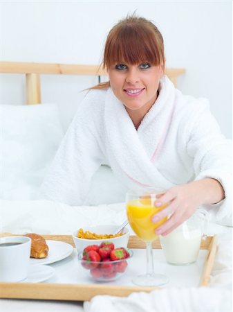 Beautiful woman eating breakfast in bed Stock Photo - Budget Royalty-Free & Subscription, Code: 400-04042383